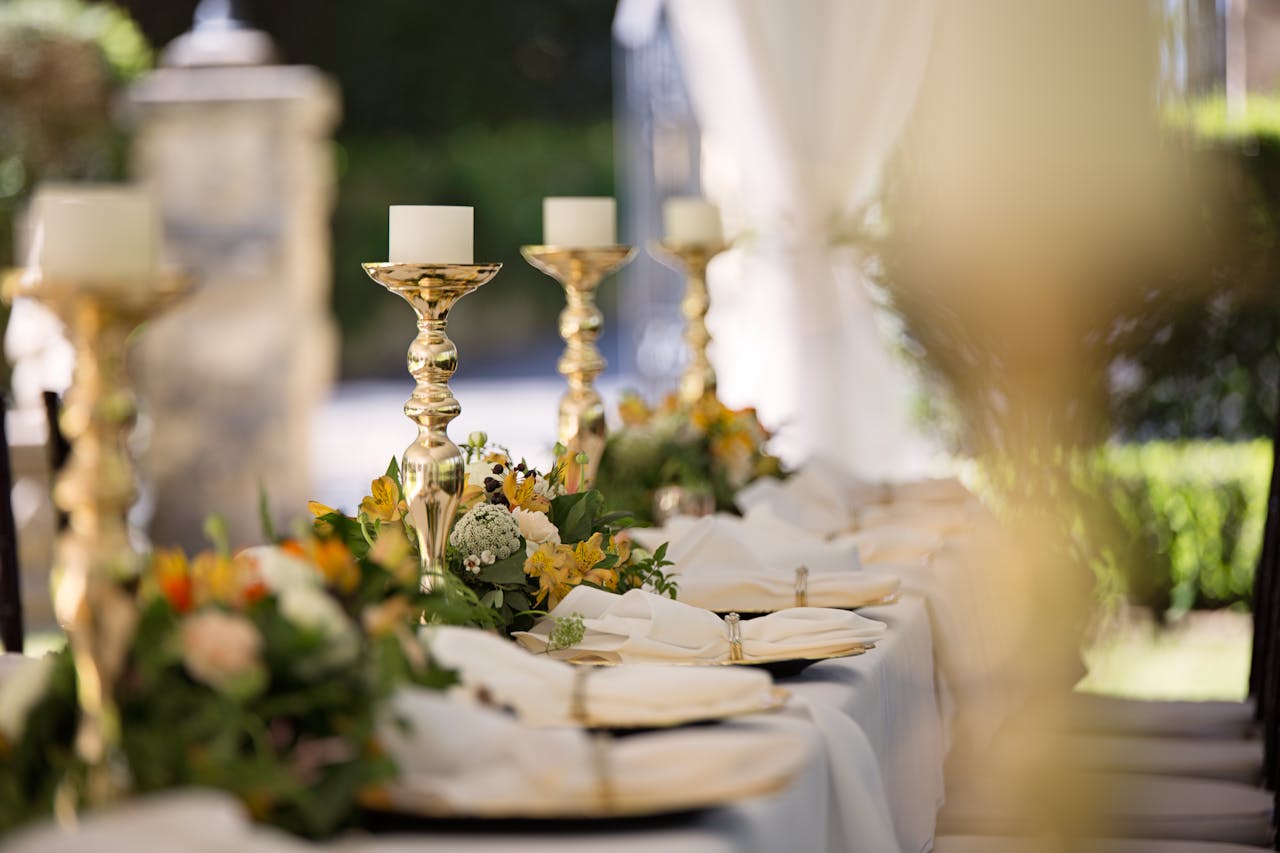 discover Luxurious outdoor wedding table setting with flowers and candlesticks.